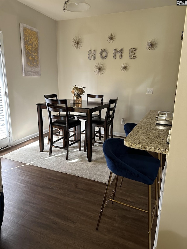 dining area with dark hardwood / wood-style floors