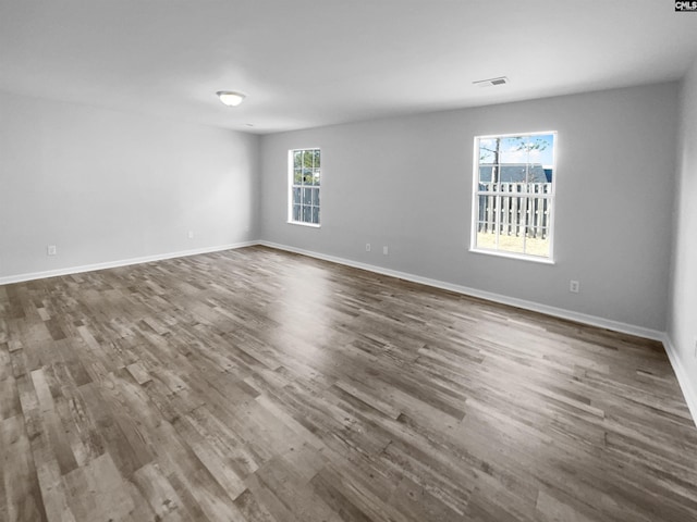 empty room with dark hardwood / wood-style flooring