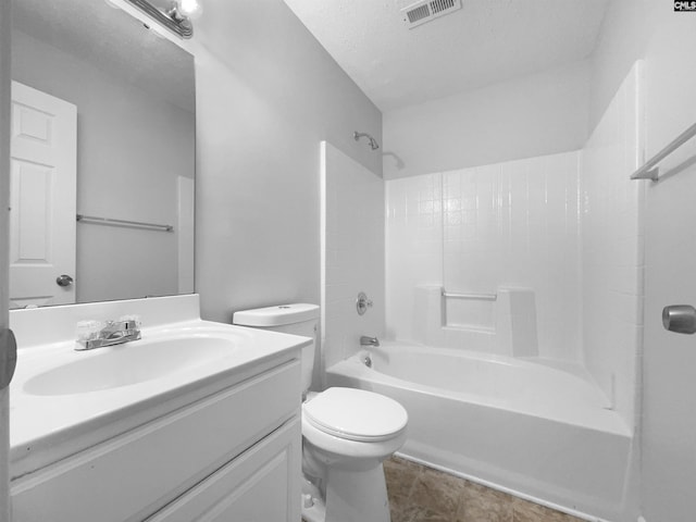 full bathroom featuring a textured ceiling, toilet, bathing tub / shower combination, and vanity