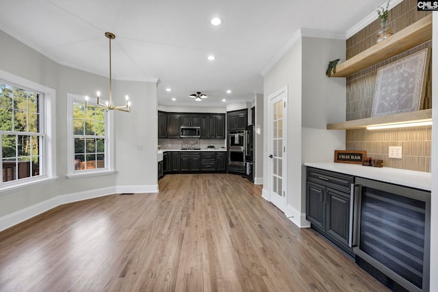 kitchen featuring stainless steel appliances, light hardwood / wood-style flooring, beverage cooler, backsplash, and crown molding