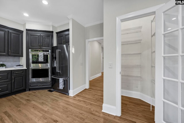 kitchen with light hardwood / wood-style flooring, decorative backsplash, stainless steel double oven, high end fridge, and ornamental molding