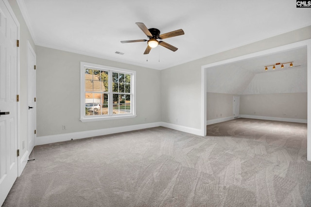 interior space featuring light colored carpet, ceiling fan, and vaulted ceiling