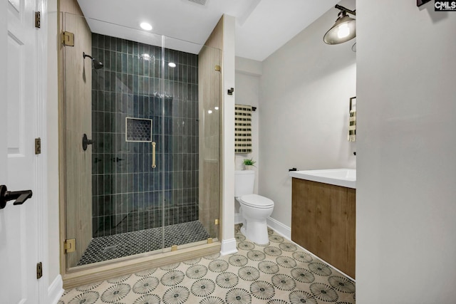 bathroom featuring toilet, a shower with shower door, and vanity