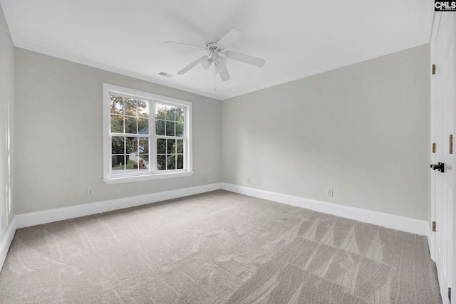 carpeted empty room with ceiling fan and crown molding