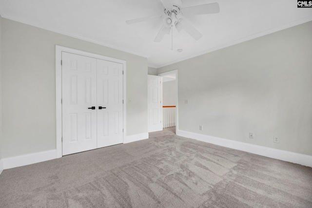 unfurnished bedroom with a closet, ornamental molding, ceiling fan, and light carpet