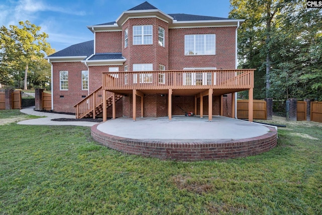 back of house with a patio, a wooden deck, and a yard