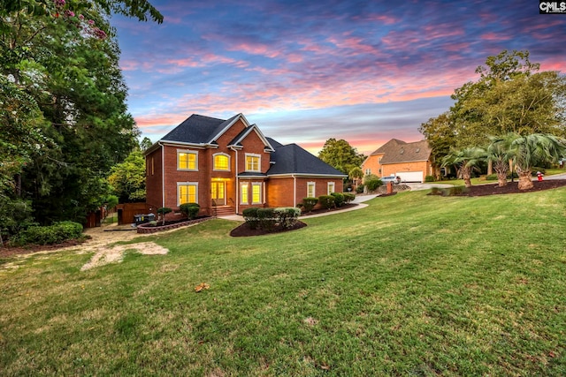 view of front of home featuring a yard and a garage