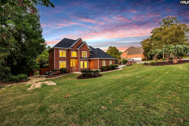 view of front of property with a yard and a garage