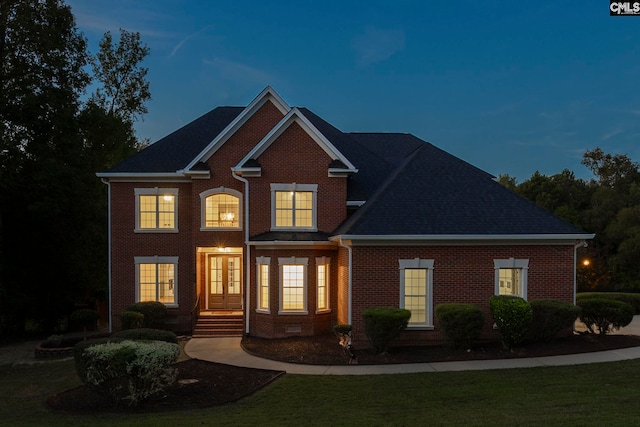 view of front of home featuring a yard and french doors