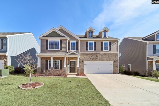 view of front of house with covered porch, a front lawn, and a garage