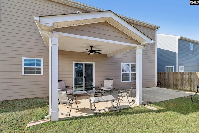 rear view of house with a patio area, ceiling fan, a lawn, and fence