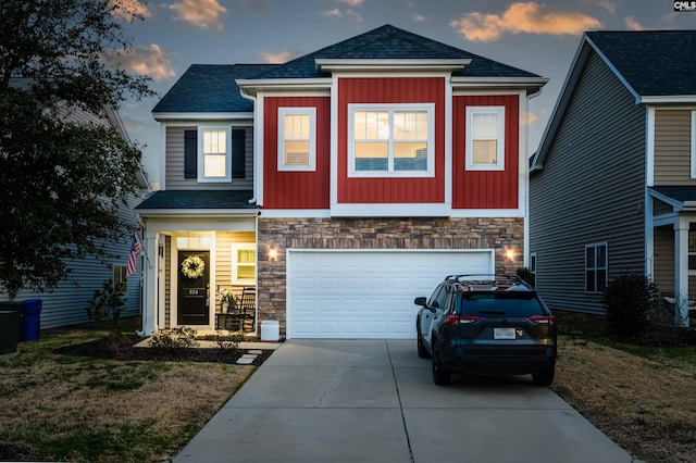 view of front of house with board and batten siding, concrete driveway, stone siding, and an attached garage