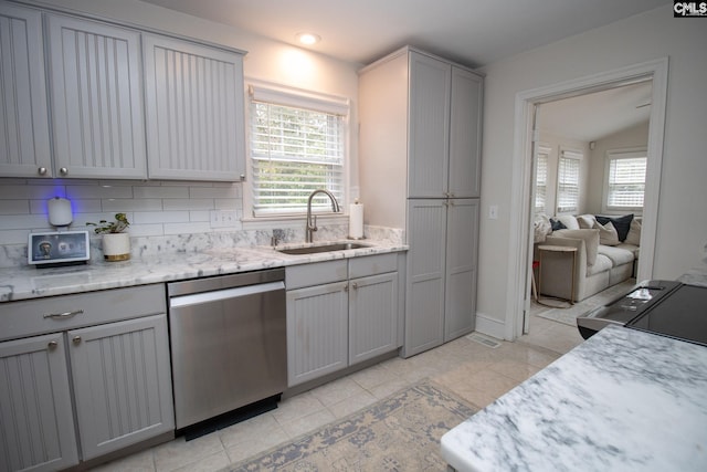 kitchen featuring sink, dishwasher, lofted ceiling, decorative backsplash, and gray cabinets