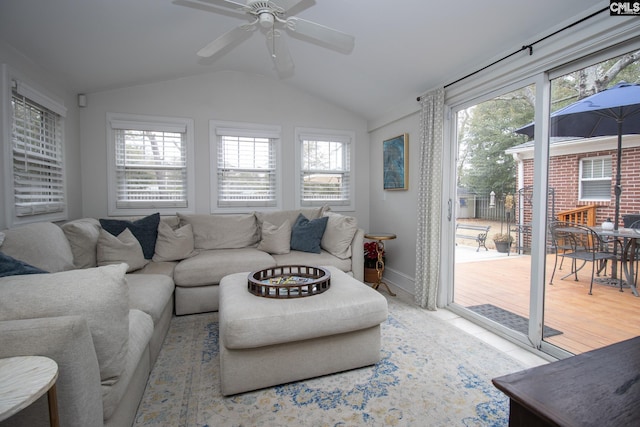 living room featuring vaulted ceiling, ceiling fan, and a healthy amount of sunlight