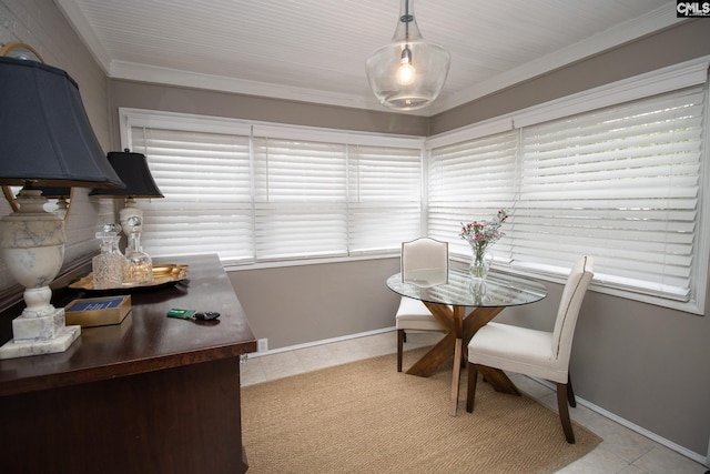 tiled dining space featuring crown molding