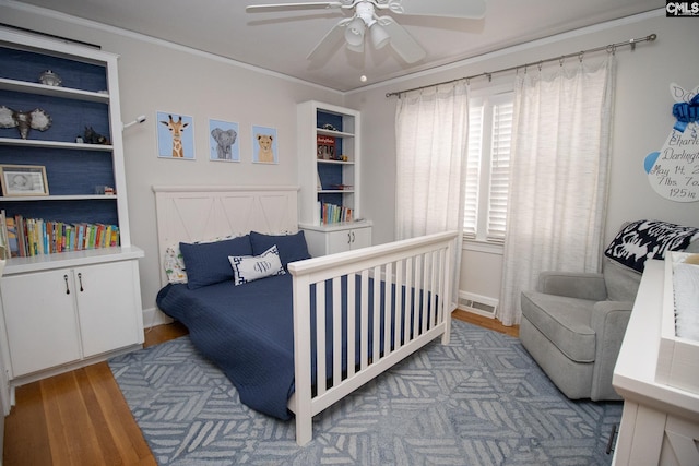 bedroom featuring crown molding, ceiling fan, and light hardwood / wood-style flooring