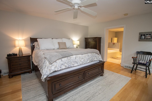 bedroom featuring ensuite bath, ceiling fan, and light hardwood / wood-style flooring