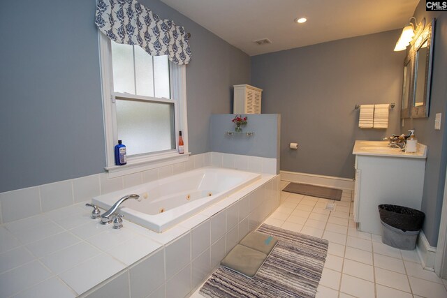 bathroom featuring a relaxing tiled tub, tile patterned flooring, and vanity