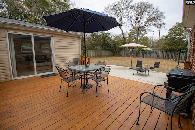 deck with an outdoor fire pit and a patio area