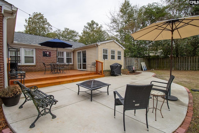 view of patio / terrace with a fire pit, grilling area, and a wooden deck