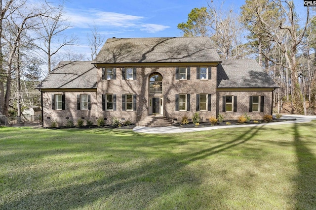 colonial home with a front lawn