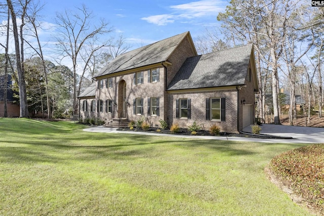 view of front of house with a front yard and a garage