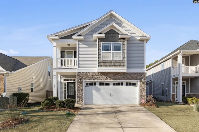 view of front of house with a front yard, a balcony, and a garage