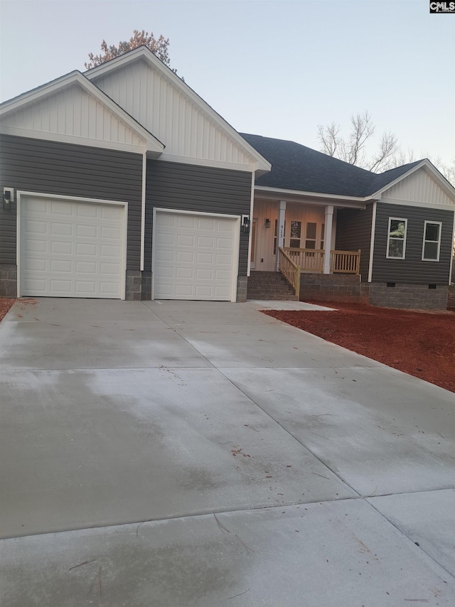 ranch-style house with a garage and a porch