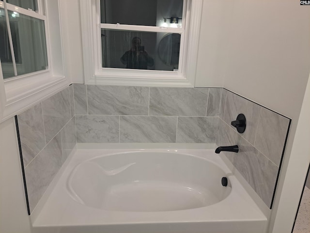 bathroom with a tub to relax in