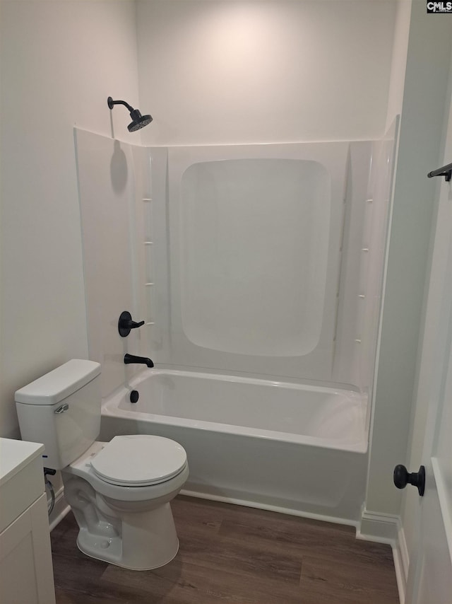 full bathroom with washtub / shower combination, vanity, toilet, and hardwood / wood-style floors