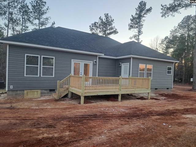 back of property with french doors, a wooden deck, and cooling unit