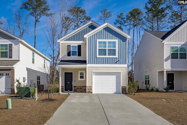 view of front of property with central AC unit and a garage