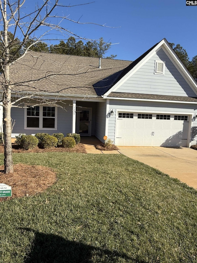 ranch-style home with a garage and a front lawn