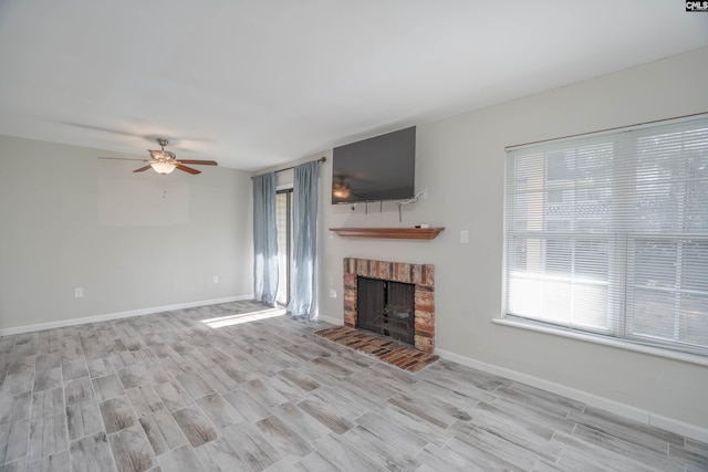 unfurnished living room with ceiling fan and a fireplace