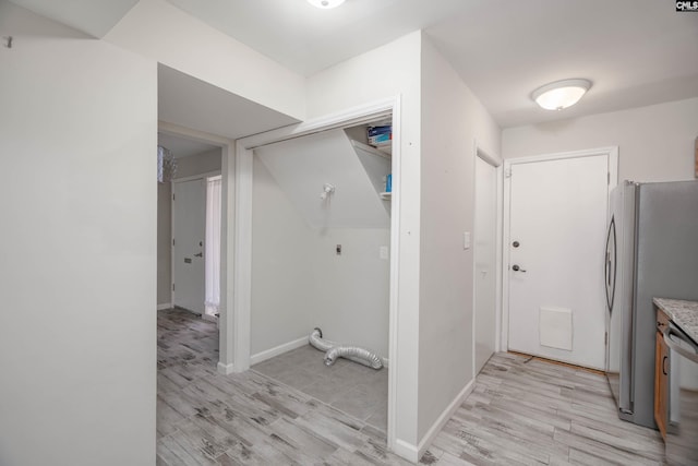 laundry area with light hardwood / wood-style flooring