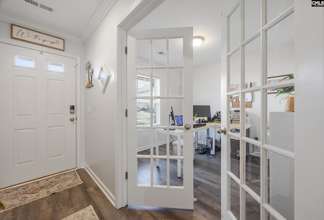 entryway featuring french doors, dark hardwood / wood-style floors, and crown molding