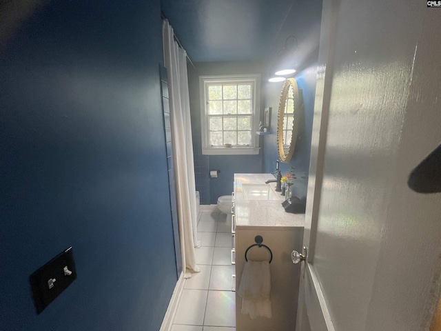 bathroom featuring toilet, vanity, and tile patterned floors