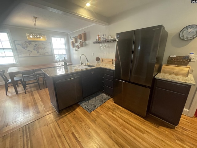 kitchen featuring kitchen peninsula, sink, stainless steel fridge, and dishwashing machine