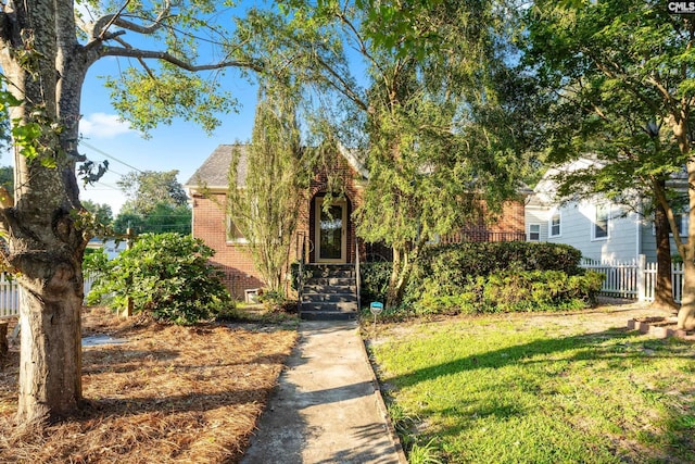 obstructed view of property featuring a front yard