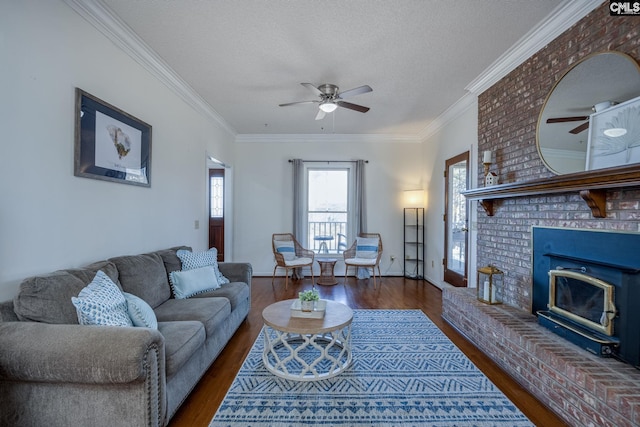 living room with a brick fireplace, a textured ceiling, and dark hardwood / wood-style flooring