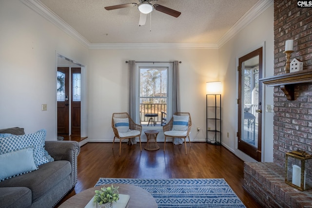 living room with a textured ceiling, ceiling fan, dark hardwood / wood-style flooring, and crown molding