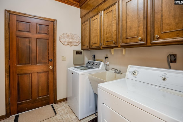 laundry area with separate washer and dryer and cabinets