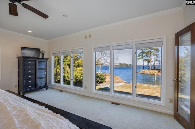 unfurnished bedroom with ceiling fan, crown molding, and carpet flooring