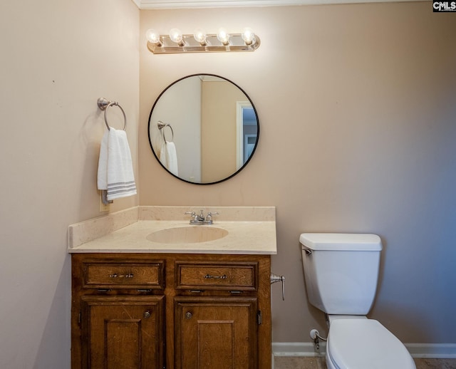 bathroom featuring toilet and vanity