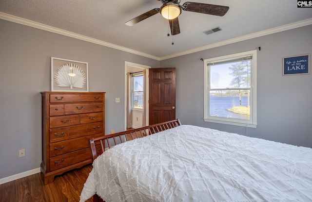 bedroom with ceiling fan, dark wood-type flooring, crown molding, and a textured ceiling