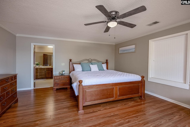 bedroom featuring ceiling fan, hardwood / wood-style floors, a textured ceiling, connected bathroom, and ornamental molding