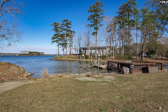 view of dock featuring a water view and a lawn