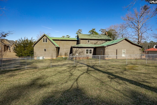 back of house with a lawn