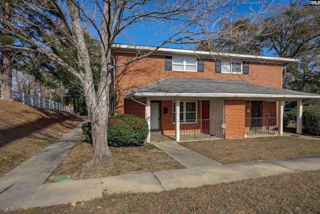 view of front of home featuring a front yard and covered porch