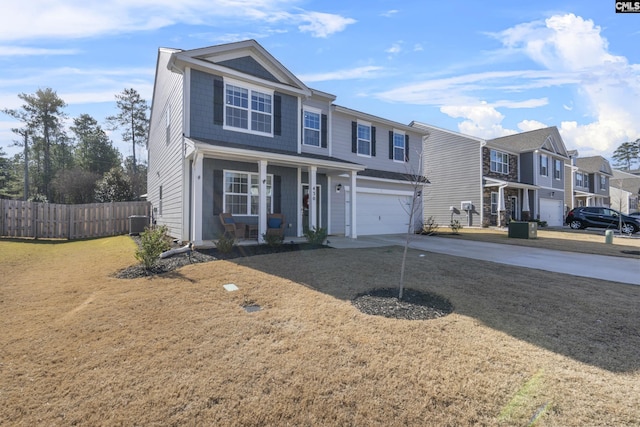 view of front facade featuring a front yard, a garage, and a porch